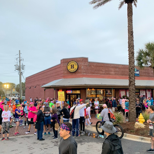 Looking at Homespun Kitchen Atlantic Beach from the outside with a crowd of runners from the Donna Marathon